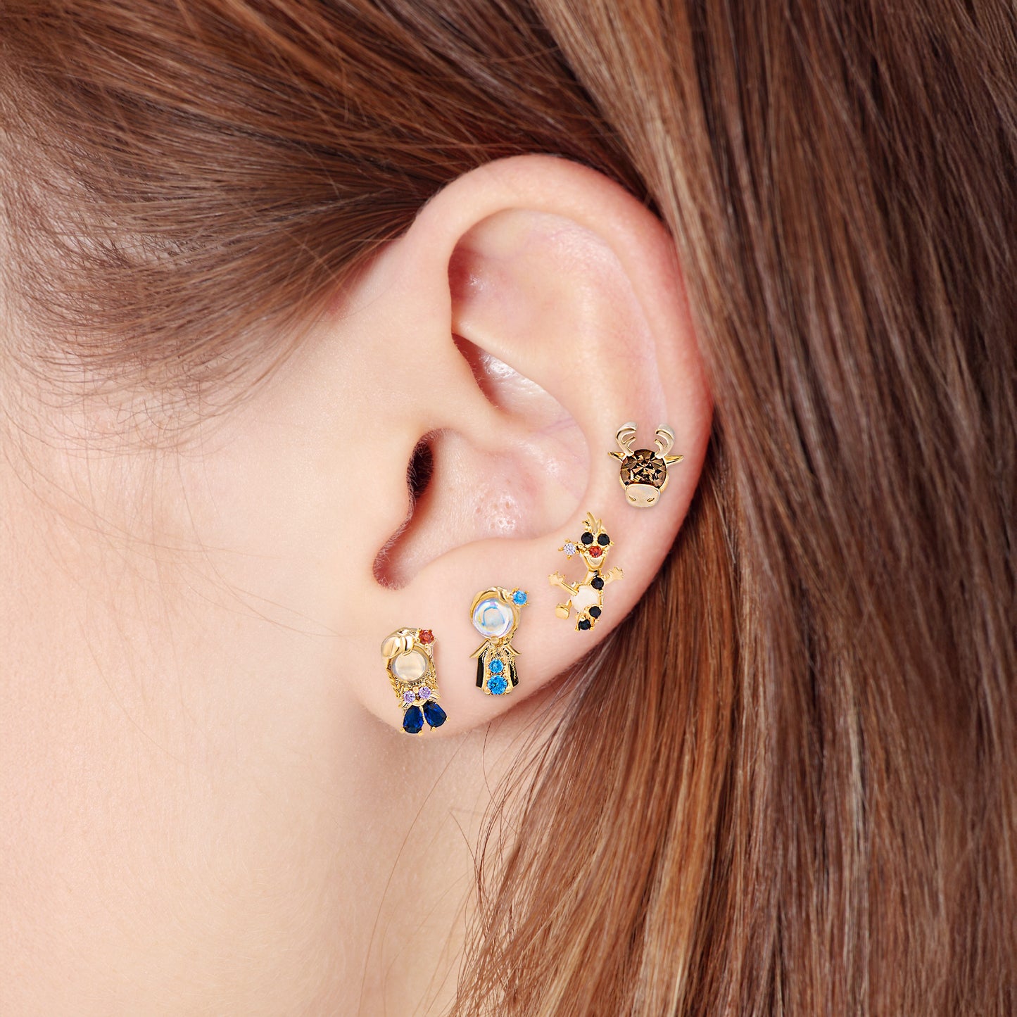 Close-up of an ear wearing Frozen earring set