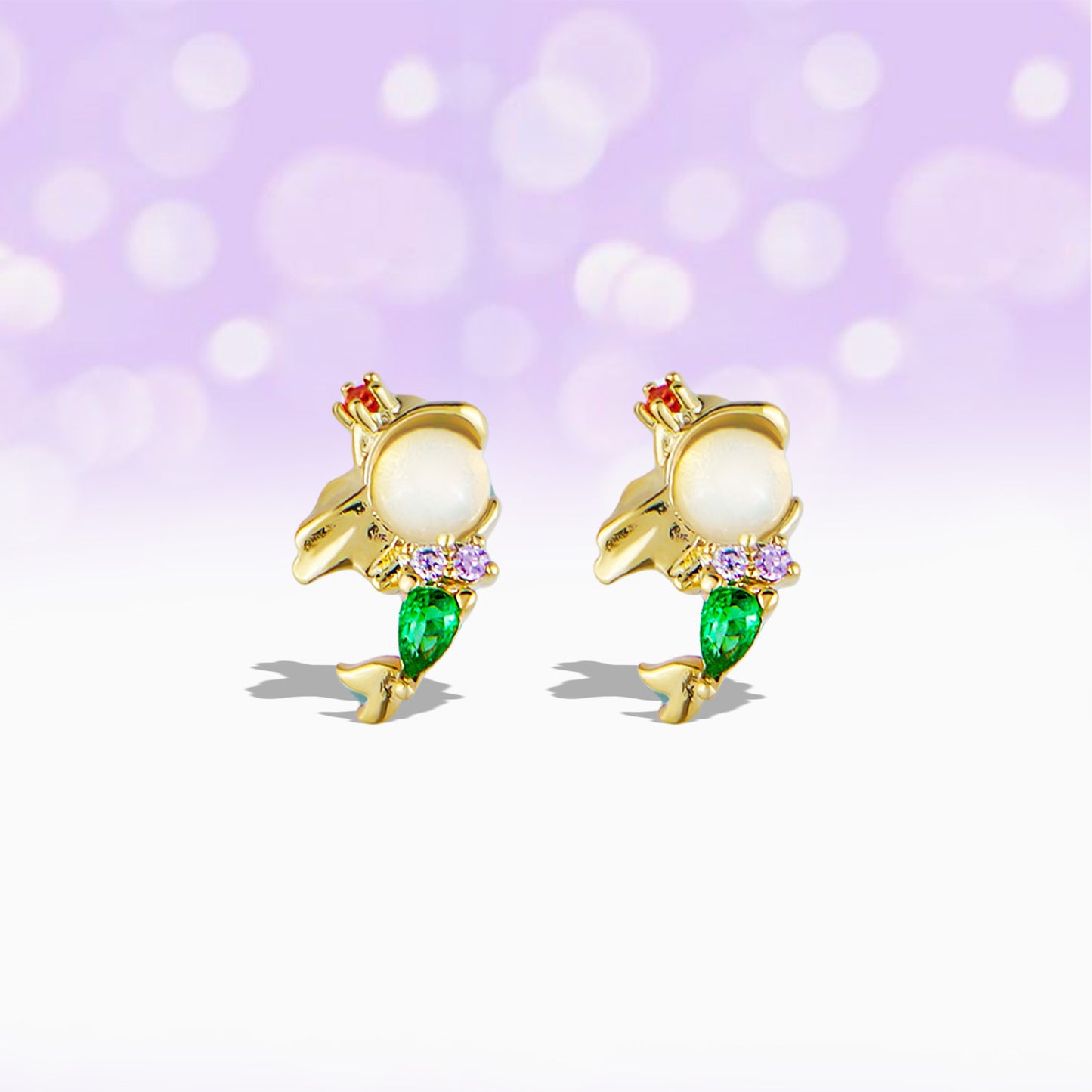 Gold Princess Ariel stud earrings  with pearls and purple gemstones on a white background