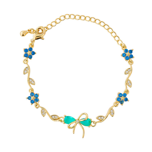 Gold bracelet with blue bow on a white background