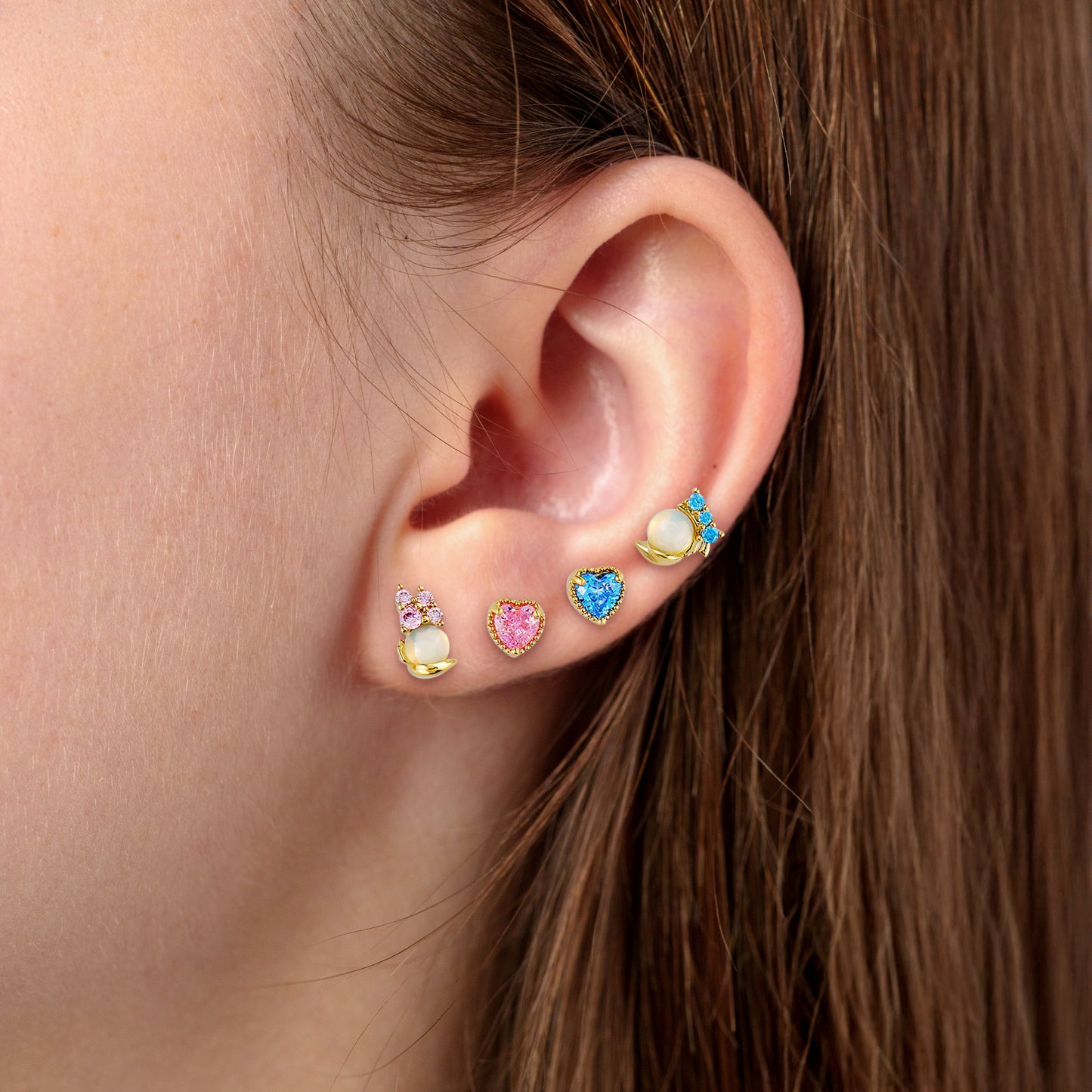 Close-up of an ear wearing Daisy and Donald earring set.