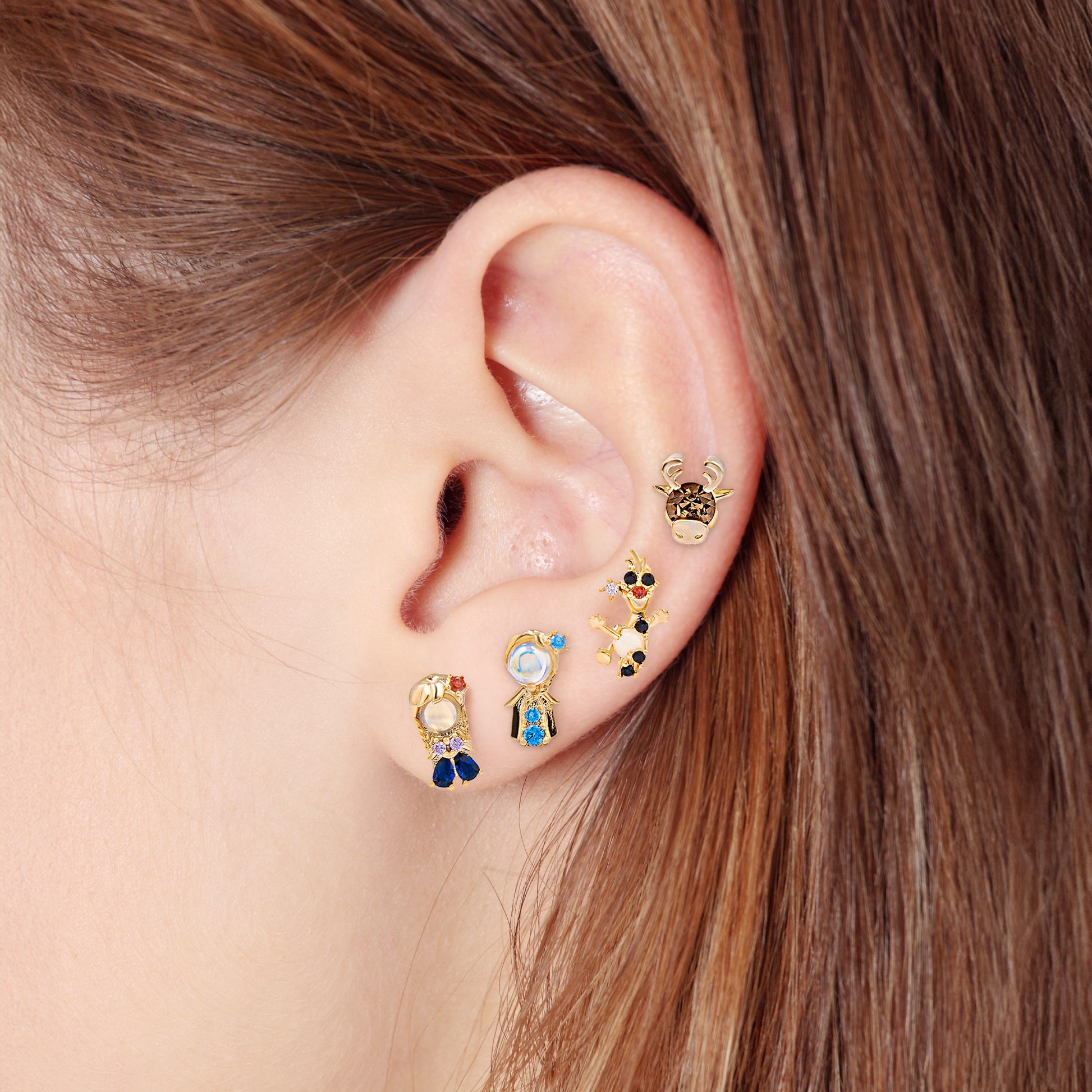 Close-up of an ear wearing Frozen earring set