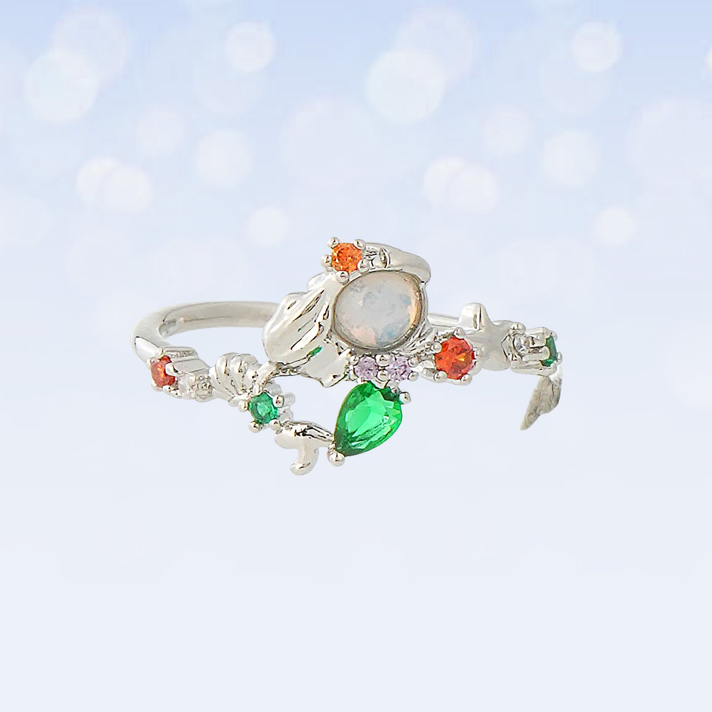 Princess Ariel silver ring with colorful gemstones on a light blue background