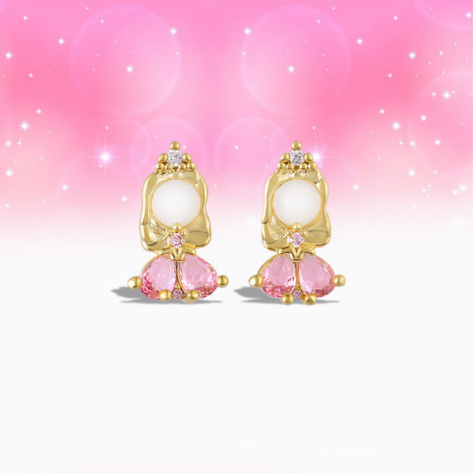 Pair of gold Princess Aurora earrings with pink gemstones on a gradient pink background