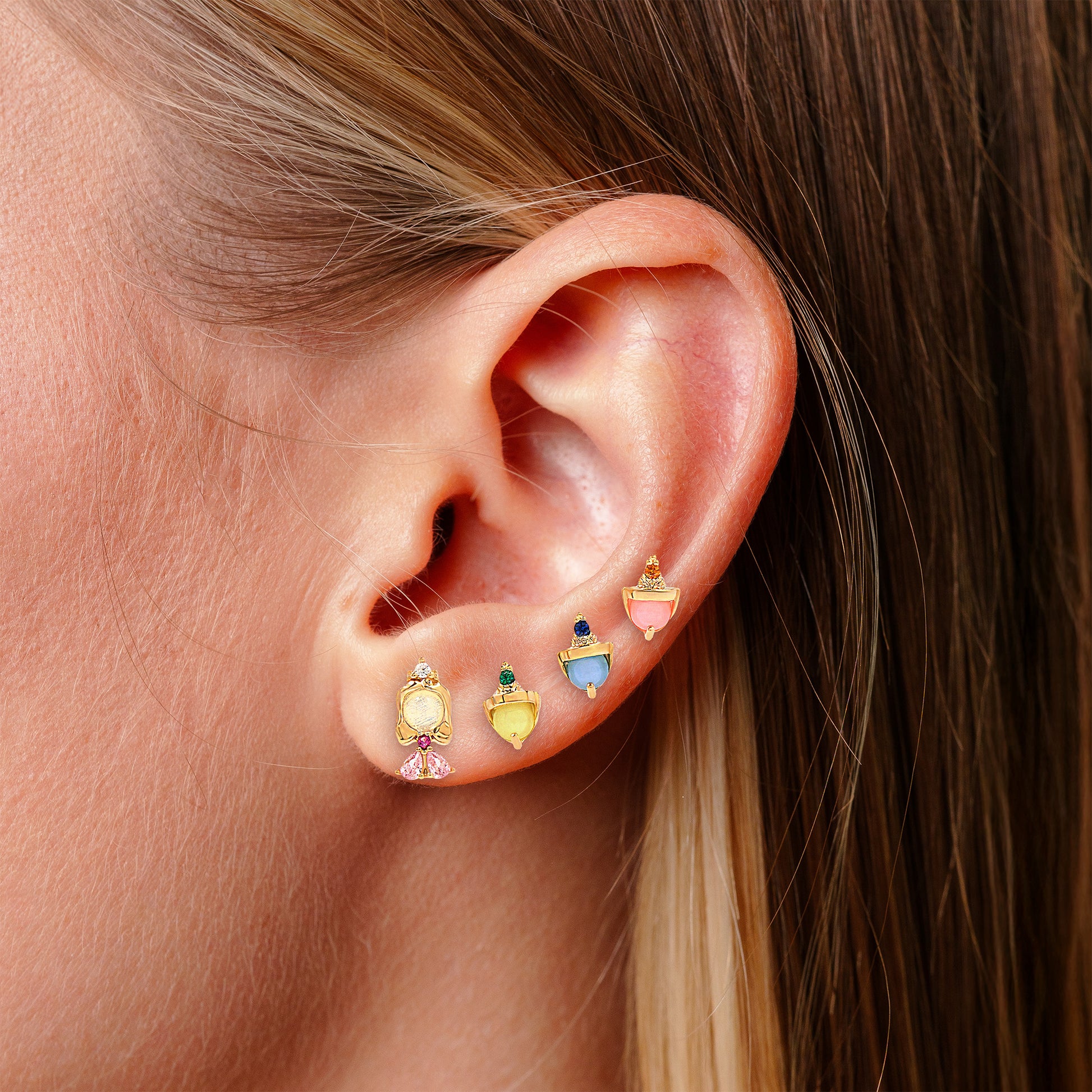 Close-up of an ear wearing Sleeping Beauty Earring studs. 