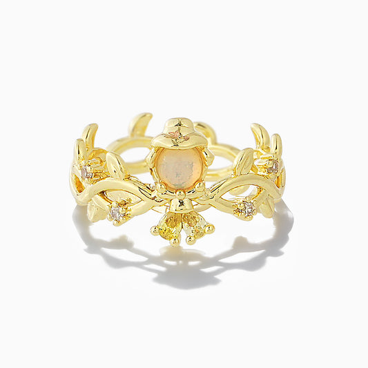 Gold Belle ring with a central gemstone on a white background